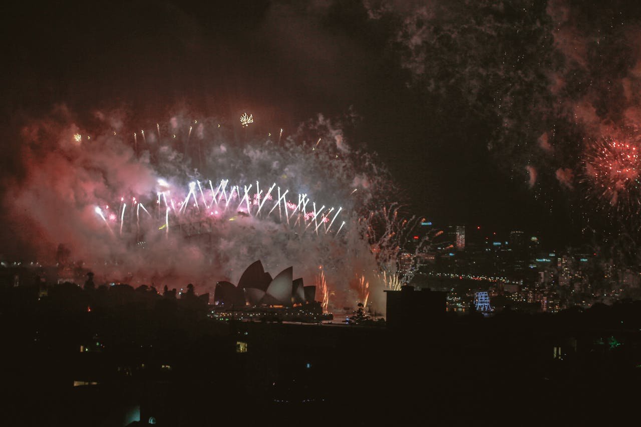 Fireworks display lighting up the night sky over Sydney Opera House.